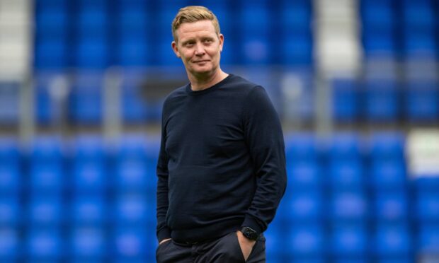 Raith Rovers manager Barry Robson stands with his hands in his pockets.