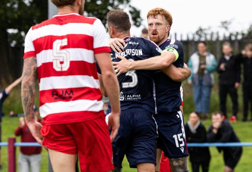 Skipper Simon Murray congratulates Clark Robertson after Dundee's opening goal. Image: Ross Parker/SNS