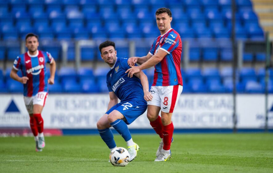 St Johnstone midfielder Stevie Mallan has his eyes on the ball as he is challenged by Raith Rovers rival Ross Matthews.