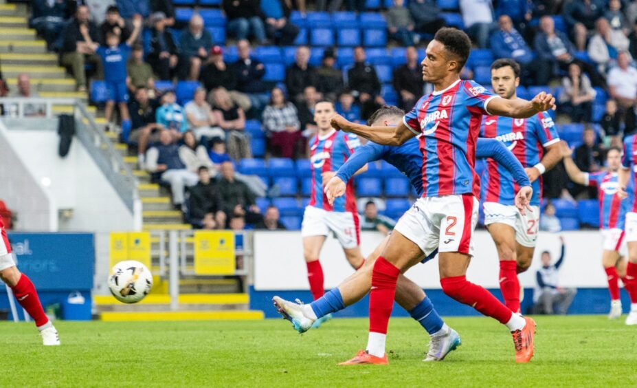 Josh McPake beats Raith Rovers defender Jai Rowe to the ball to shoot at goal.