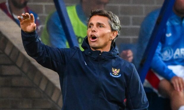 St Johnstone manager Simo Valakari raises his right arm and shouts.