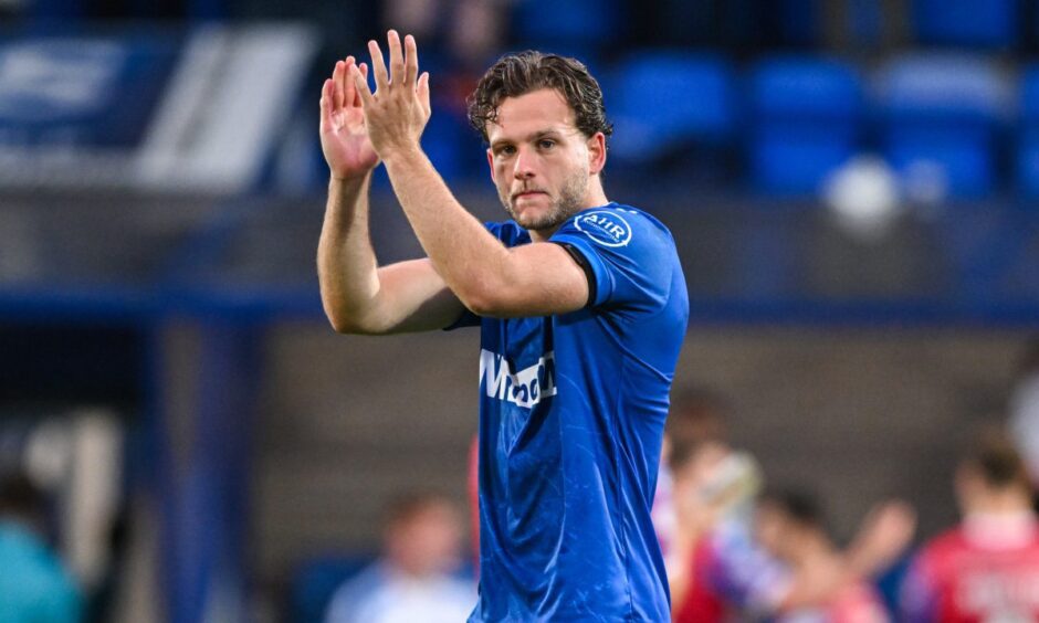 St Johnstone striker Jamie Gullan claps the home fans.