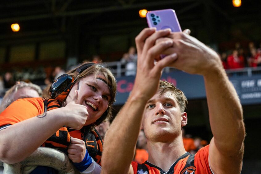 Krisztian Keresztes is poses for a selfie with a happy Tangerines supporter.