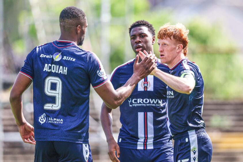 Emile Acquah and Tony Yogane celebrate with Simon Murray.