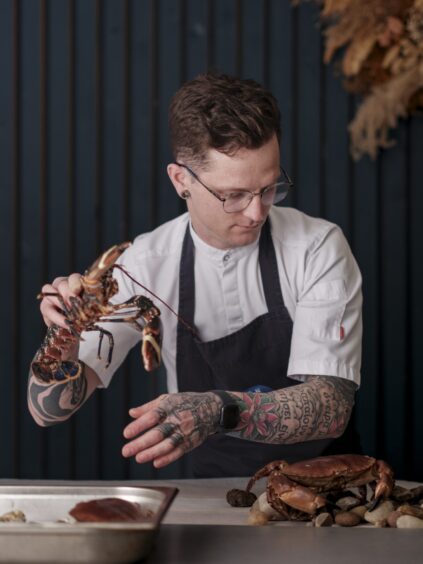 Tasso Neofitos handling some shellfish.