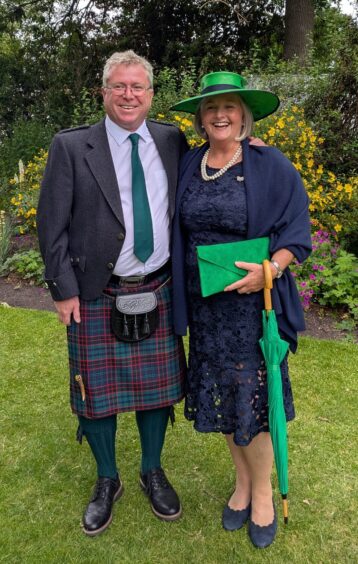 Duncan and Fiona Foster in kilt and navy dress and green hat