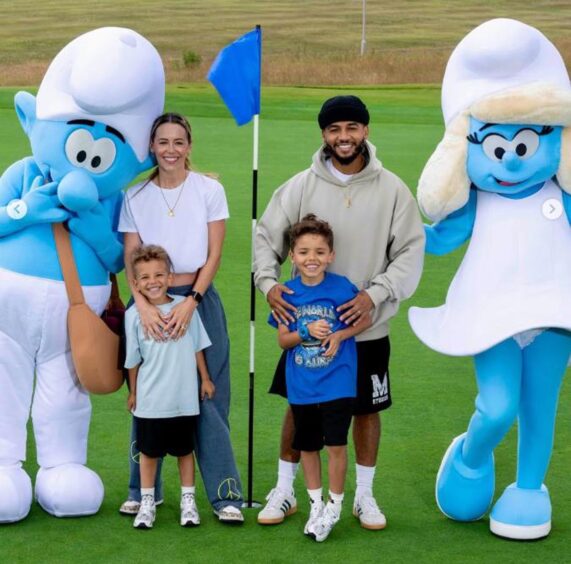 Former JLS singer Ashton Merrygold and his family on the Torrance Old Course in St Andrews with the two Smurfs.