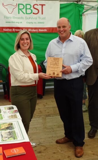 Balcaskie Estate's Sam Parsons receiving the sustainability farm of the year award from Sarah Taylor, of category sponsor Burness Paull