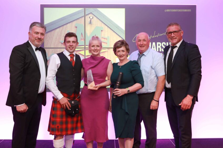 Shona Marshall, third from the left, holding the award for best large butchery in Scotland. 