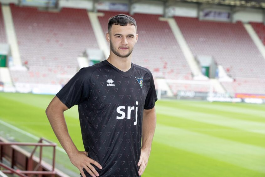 Mason Munn stands with his hands on his hips at East End Park.
