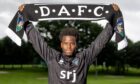 Alfons Amade holds a DAFC scarf above his head.