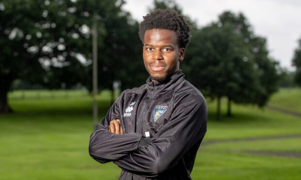 New Dunfermline Athletic signing Alfons Amade stands with his arms folded.
