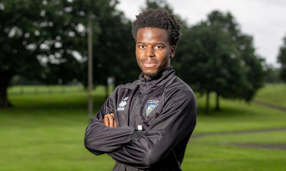 New Dunfermline Athletic signing Alfons Amade stands with his arms folded.