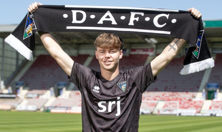 Rory MacLeod holds up a DAFC scarf.