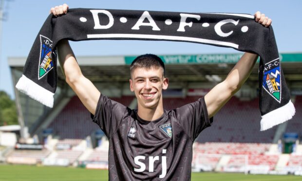 New Dunfermline Athletic signing Shea Kearney holds up a DAFC scarf.