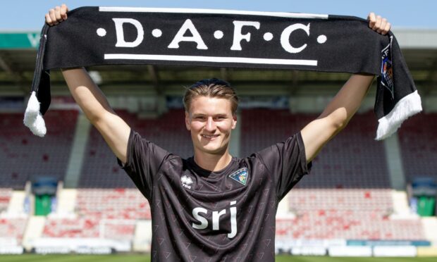 Alasdair Davidson holds up a DAFC scarf.