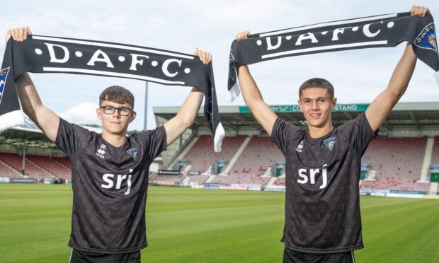 Andrew Tod and brother John hold up DAFC scarves.