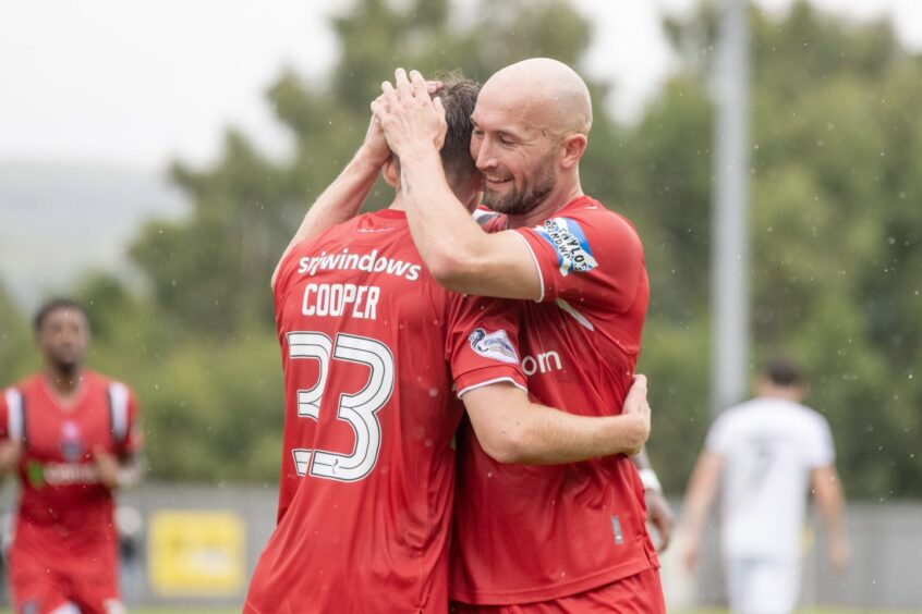 Dunfermline team-mates Josh Cooper and Chris Kane congratulate each other.