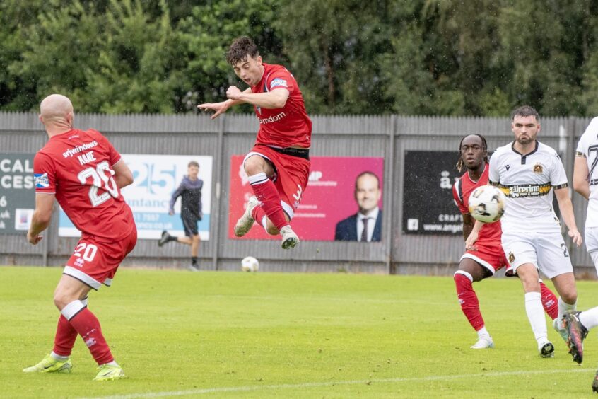 A leaping Josh Cooper acrobatically volleys in his second goal for DAFC against Dumbarton.