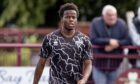 Alfons Amade warms up before his friendly debut with Dunfermline Athletic.