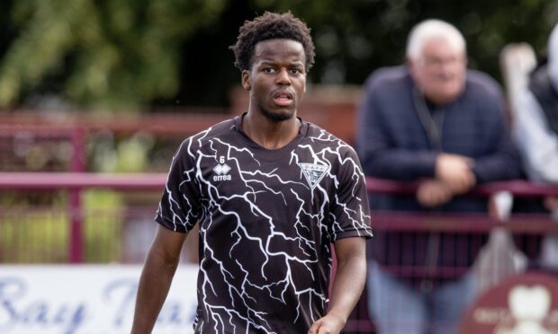 Alfons Amade warms up before his friendly debut with Dunfermline Athletic.