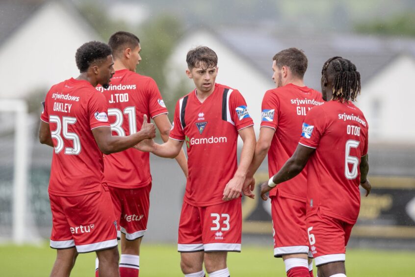 Josh Cooper is congratulated by his Dunfermline Athletic team-mates after scoring against Dumbarton.