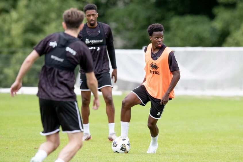 Alfons Amade gets on the ball during training with the Pars.