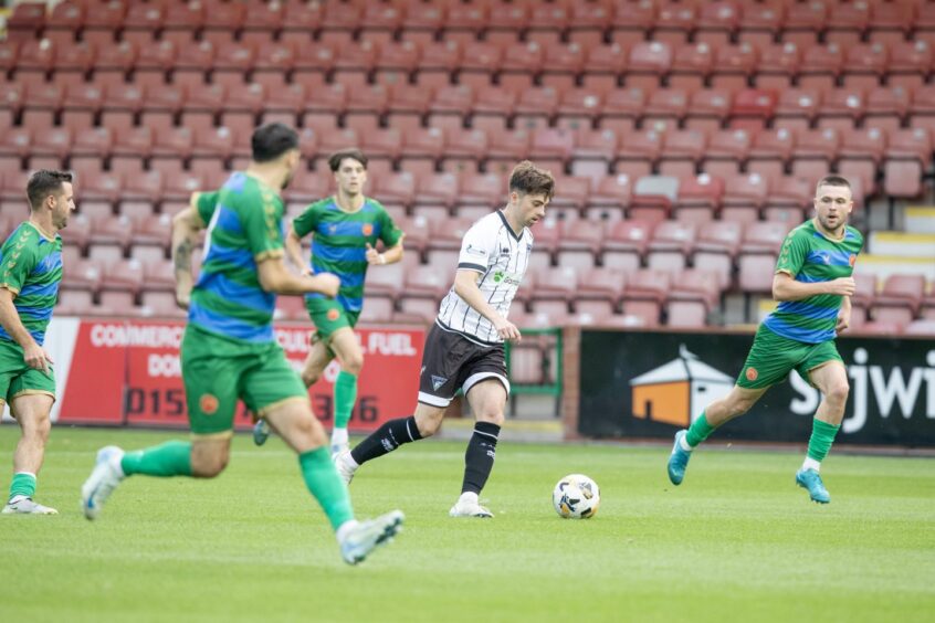 Dunfermline Athletic attacker Josh Cooper has the ball at his feet and is pursued by four Hamilton Accies players.