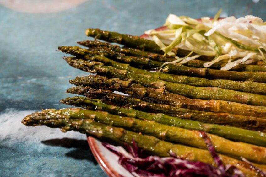A plate of cooked asparagus.