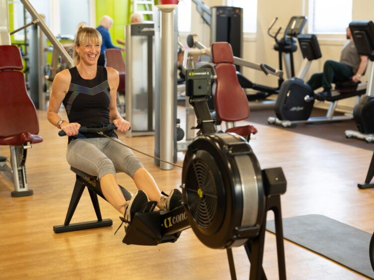 Woman on rowing machine in gym