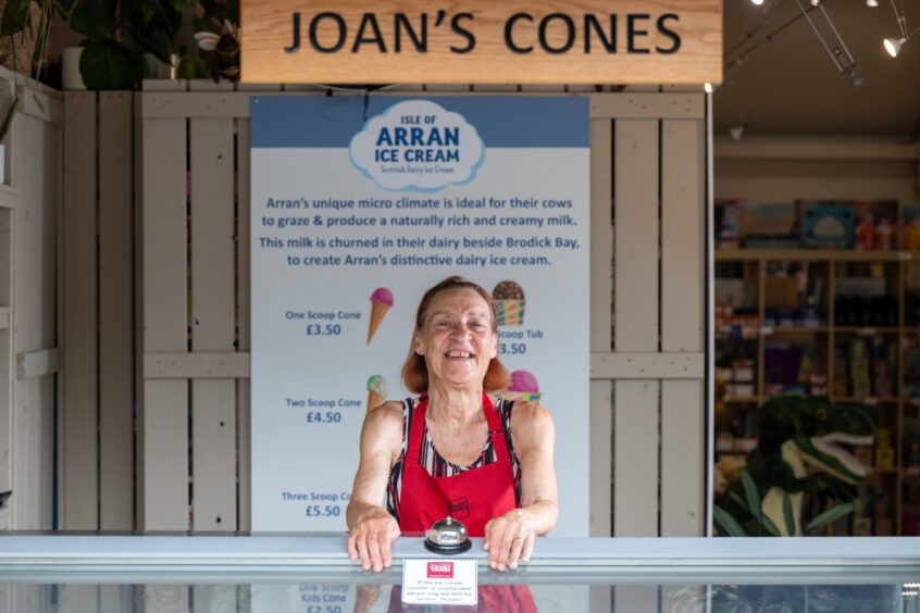 Joan Veith smiling behind ice cream counter