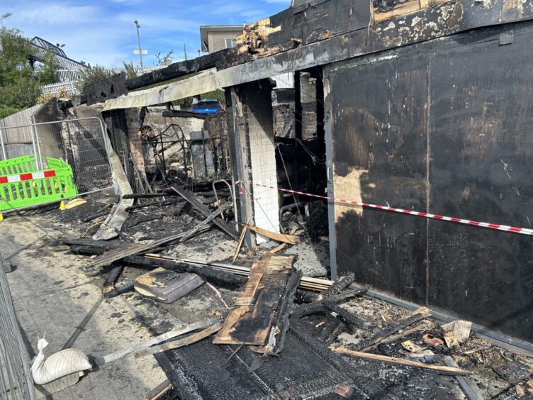 The row of three garages were destroyed in the blaze.