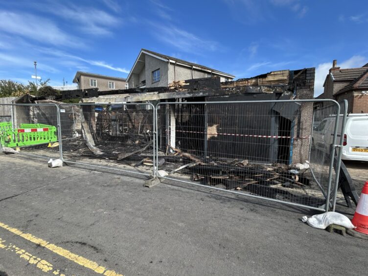 The gutted building has been fenced off for safety.