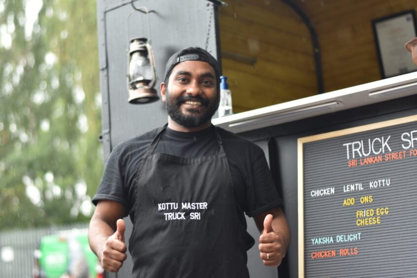 Angelo smiling by his food truck.