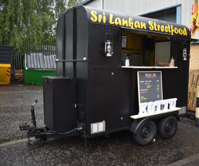 Truck Sri parked in a car park.