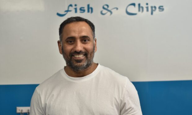 Kamran Ishaq smiling in The Plaice To Be in Pitlochry