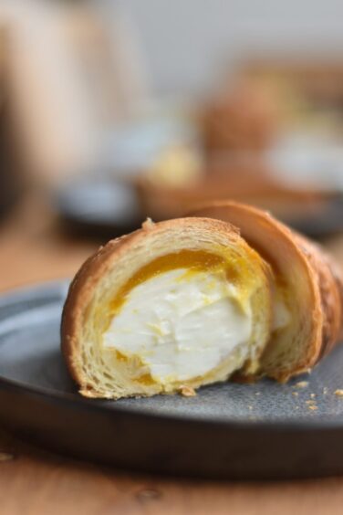 The mascarpone and mango stuffed croissant after being cut in half.