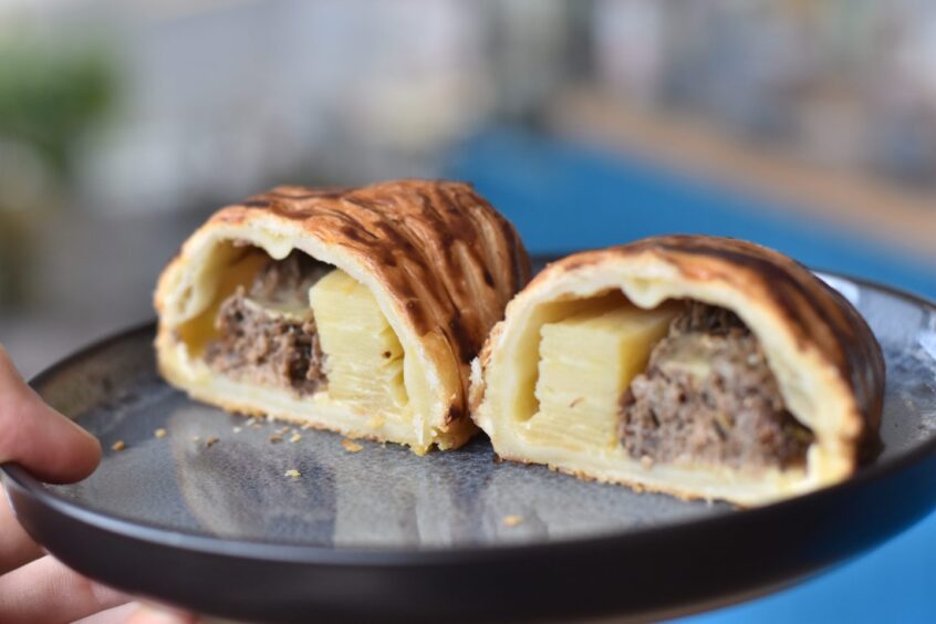 The beef shin and potato gratin pie after being cut in half.