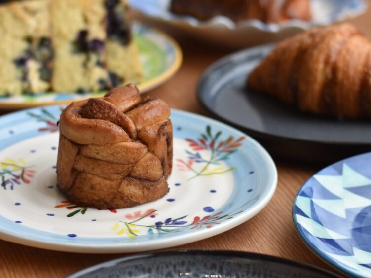 The bakery's cinnamon bun, served on a plate.