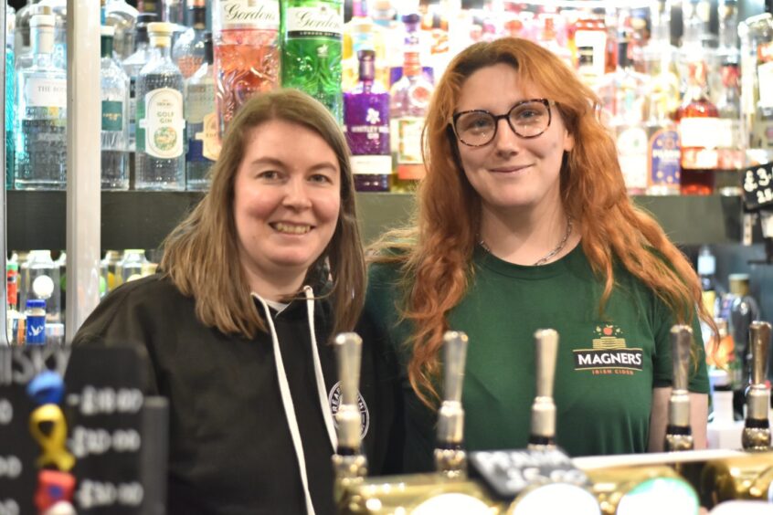 Two staff members behind the bar at The Keys Bar.