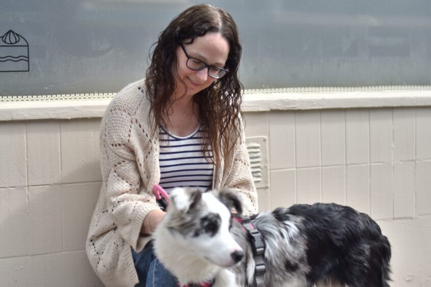 Jennifer stroking her dog, Gracie.