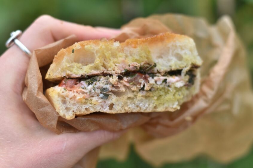 The focaccia sandwich held by Jacob Smith.