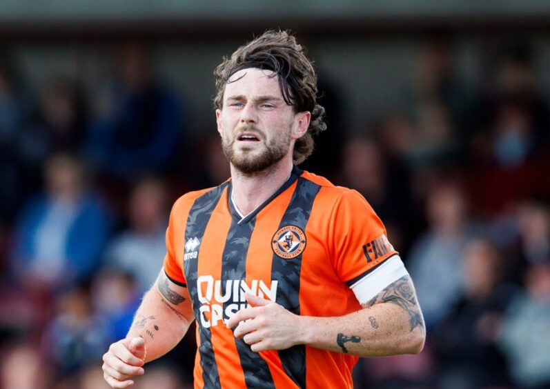 Will Ferry in action for the Tangerines, sporting the armband