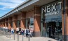 People queue outside the new store.