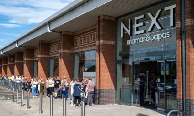 People queue outside the new store.