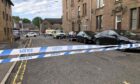 Police tape at an area of Graham Street, Dundee.