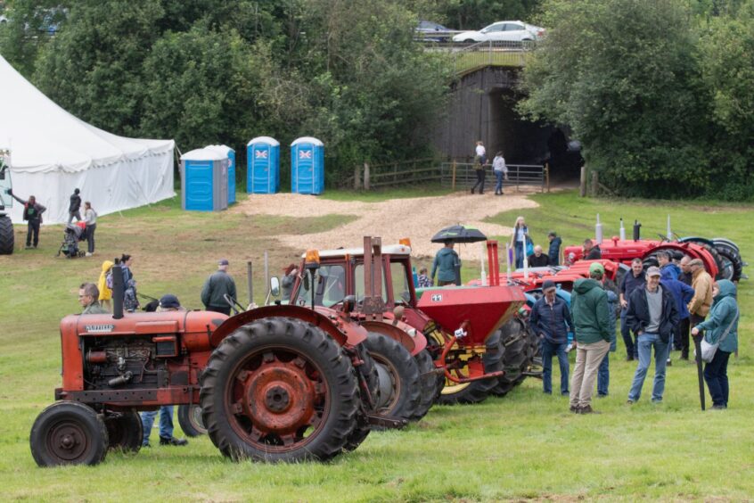Crowds gather around rows of classic tractors on a grassy slope at Doune and Dunblane Show 2025.