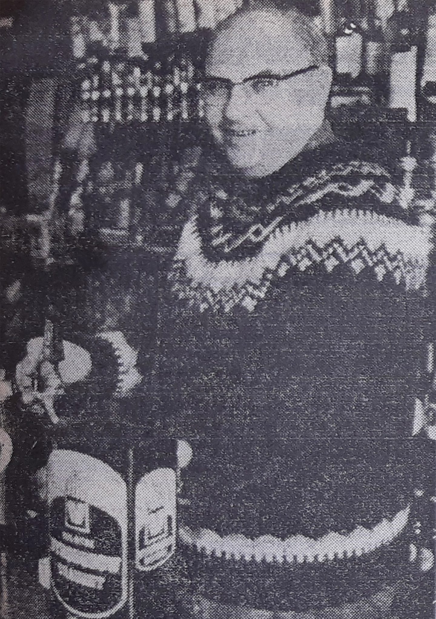 A man pouring a pint of lager in a pub.