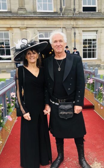 Eve Graham from the New Seekers and Thom Lester standing in front of palace