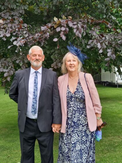 Syd Geddes and Sheena Galloway standing in front of tree